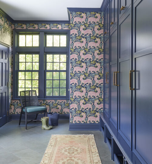 Mudroom with patterned wallpaper and navy blue paint