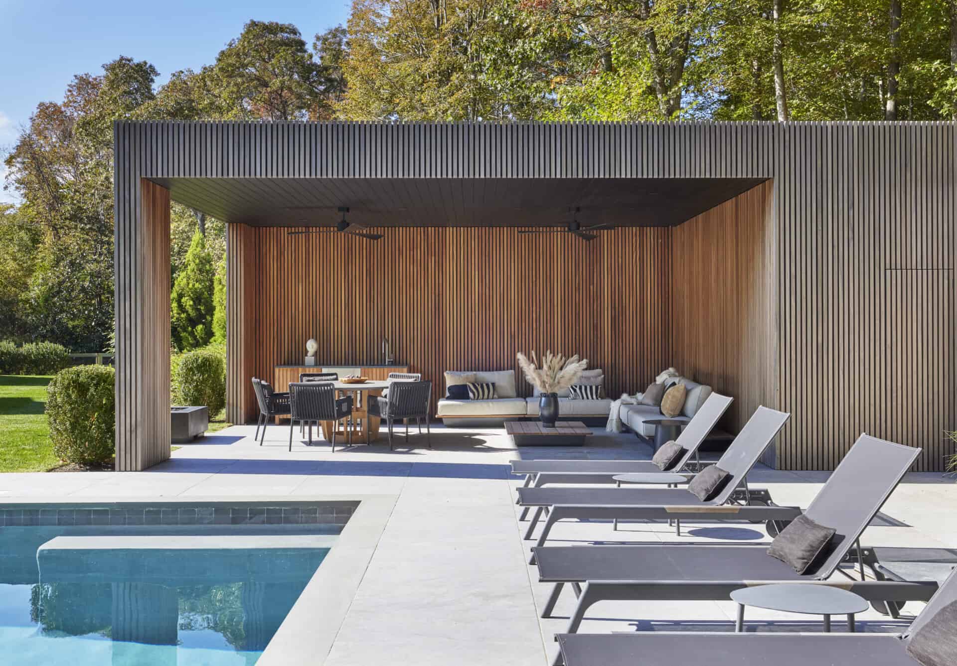 Outdoor lounge area with in-ground pool, lounge chairs, and covered outdoor patio